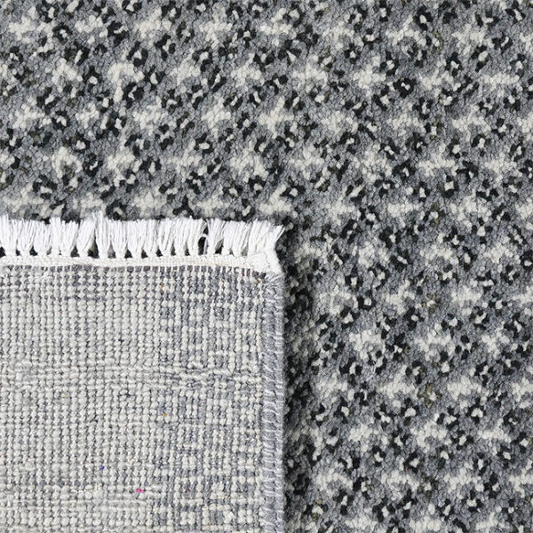 Achterkant hoek aanzicht van vloerkleed BRETTI, in de kleur grijs gemaakt van wol.